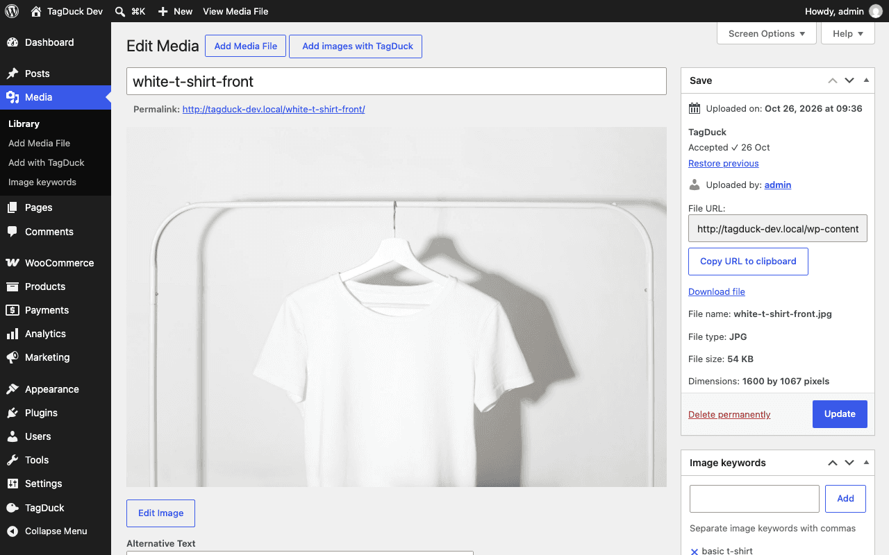 The WordPress Edit Media screen for a white T-shirt photo, with a TagDuck box in the sidebar showing "Accepted" and "Restore previous", and an Image keywords box below it.